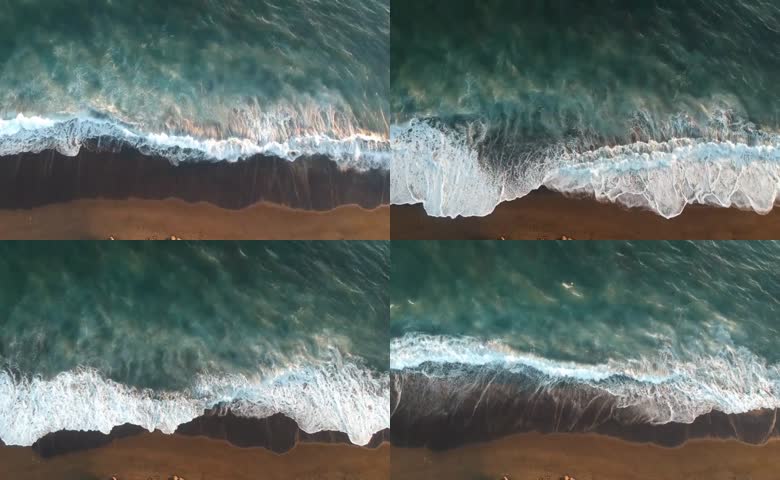 白浪冲刷黑色沙滩