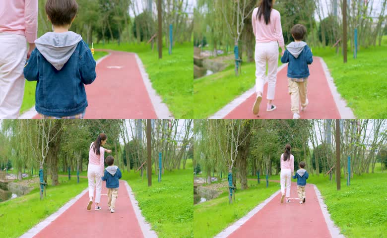 妈妈和儿子在公园里散步背影实拍