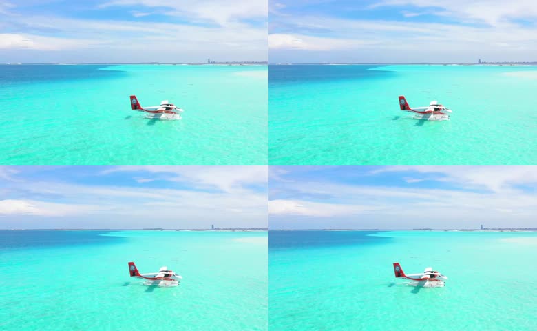 水上飞机在碧蓝海面上低空飞行